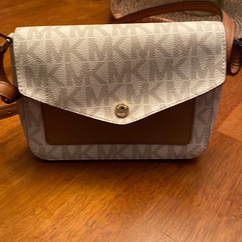 Michael Kors purse like new pen mark inside and a small stain.  Used twice
